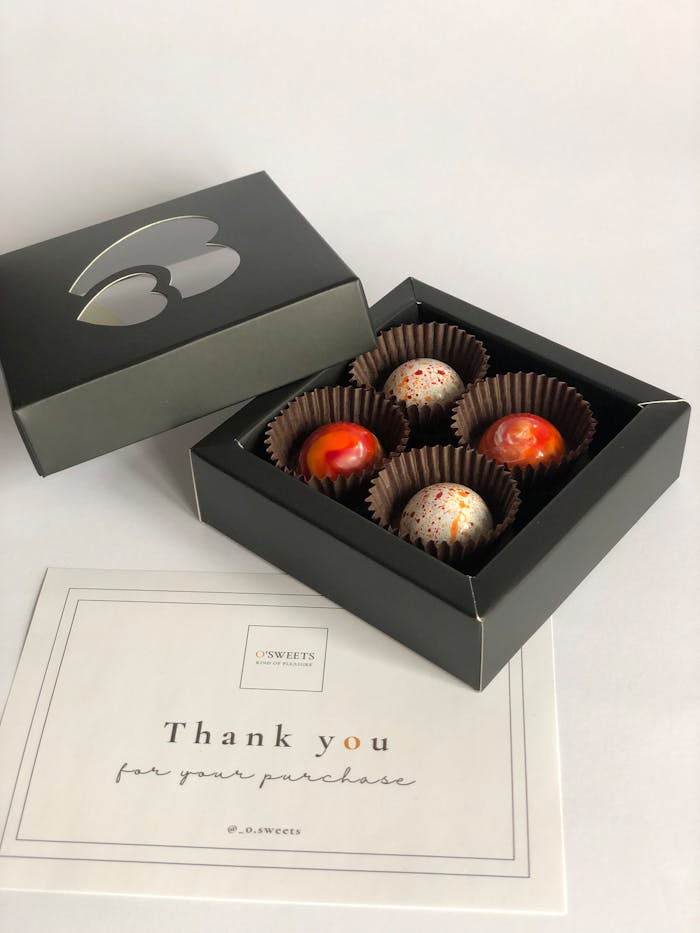 Elegantly packaged gourmet pralines with a thank you card, perfect for gifts and celebrations.